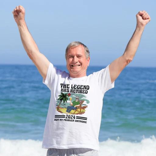 Happy retired man at the beach wearing a T-shirt, an example of personalized retirement gifts