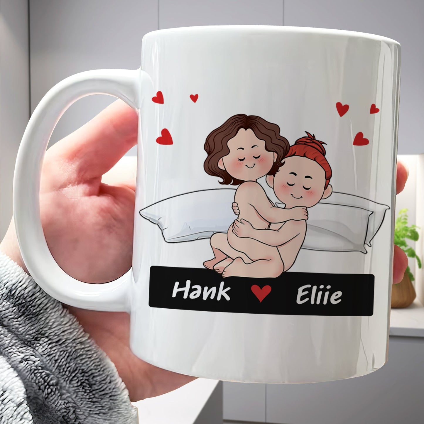 White personalized mug with cartoon couple cuddling on a bed hearts and names Hank and Eliie funny romantic gift for couples