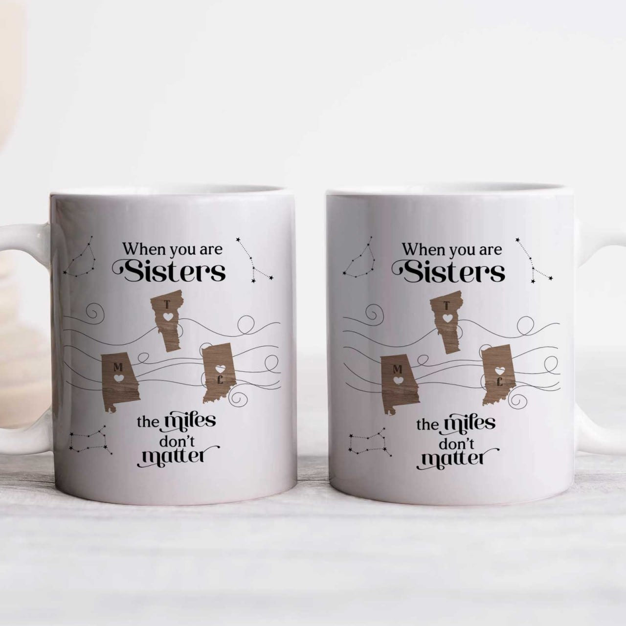 Pair of white matching sister mugs with postcards and hearts that say the miles dont matter unique gift for long distance friends