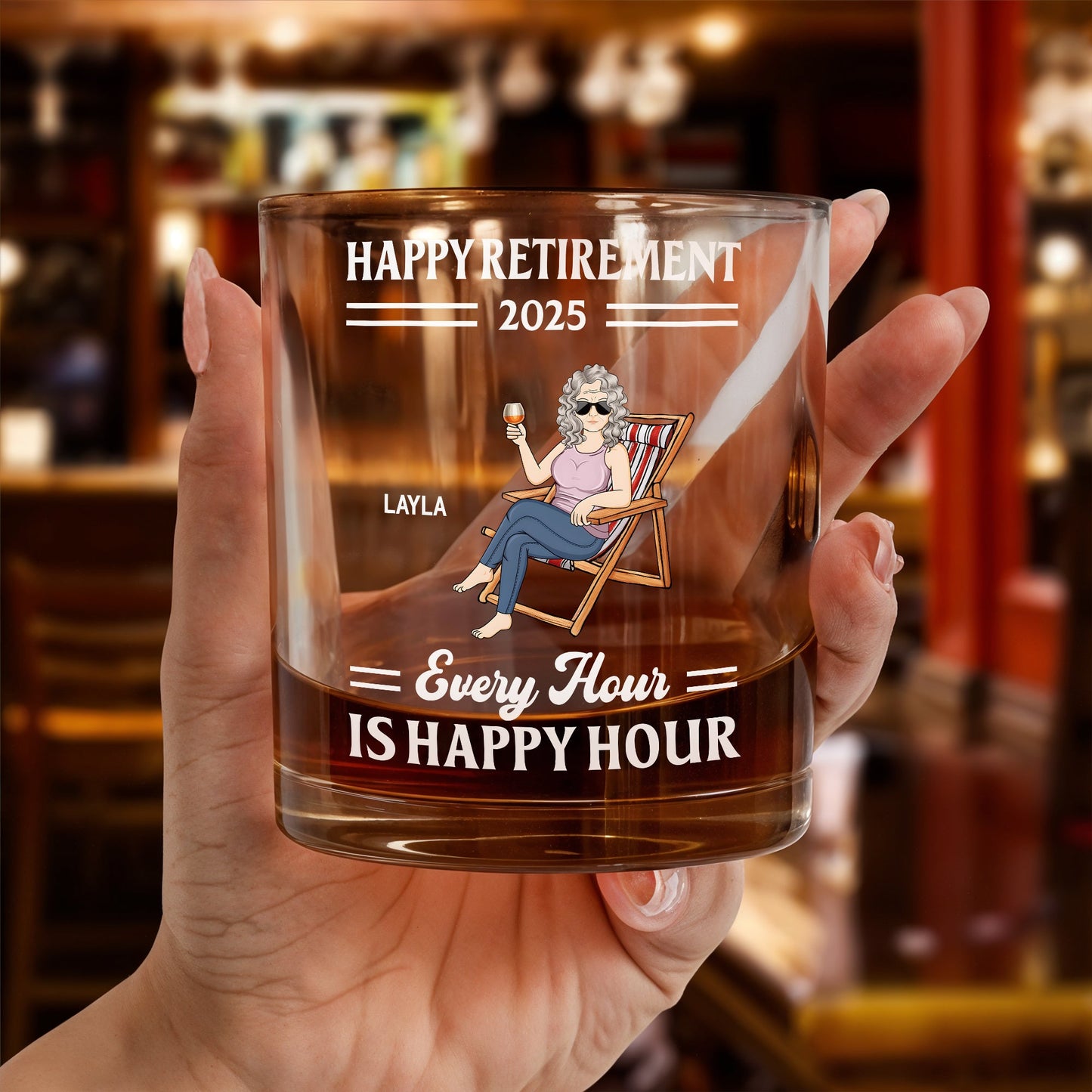 Personalized Whiskey Glass Happy Retirement 2025 design with seated woman illustration and Every Hour is Happy Hour text