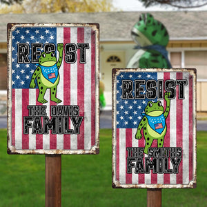 Personalized patriotic metal sign featuring cartoon frog design with custom family names and American flag backdrop