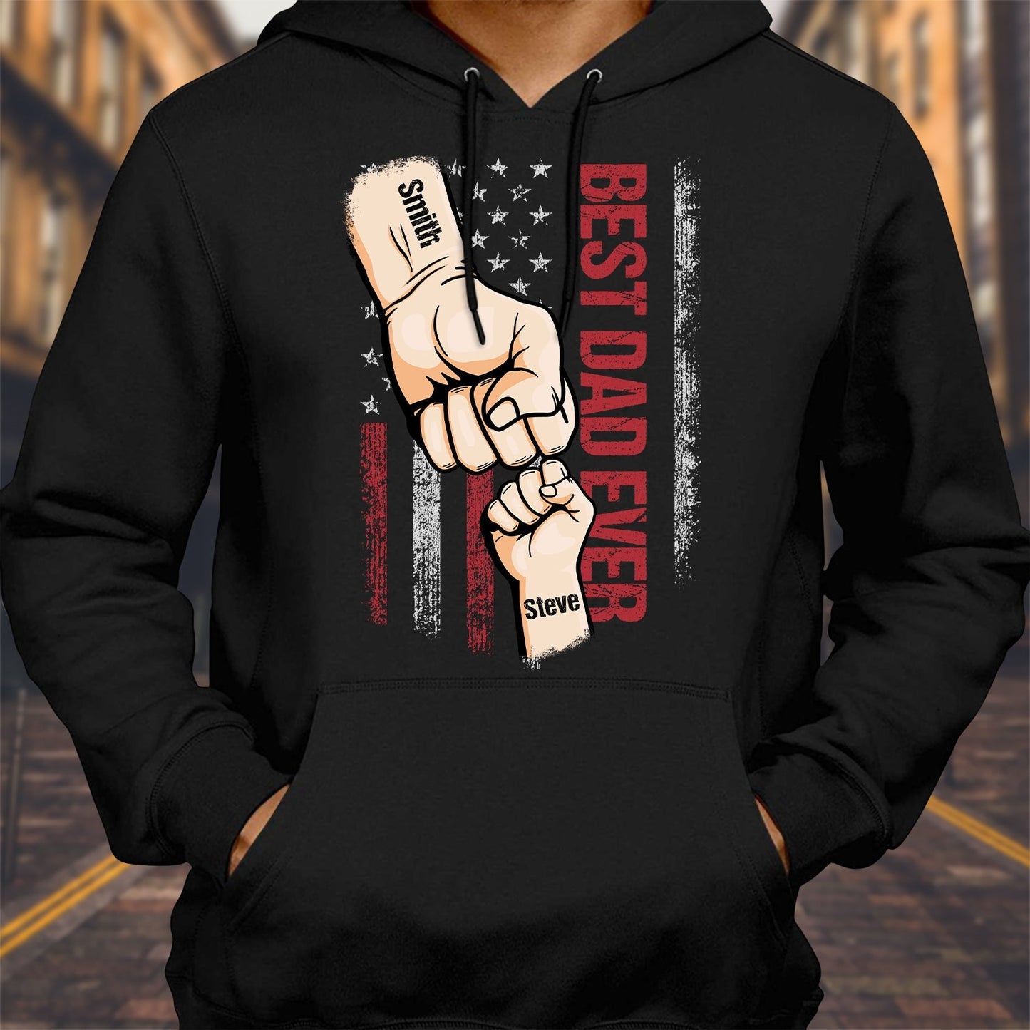 Black hoodie featuring best dad ever custom t-shirt design with adult and child fist bump and American flag