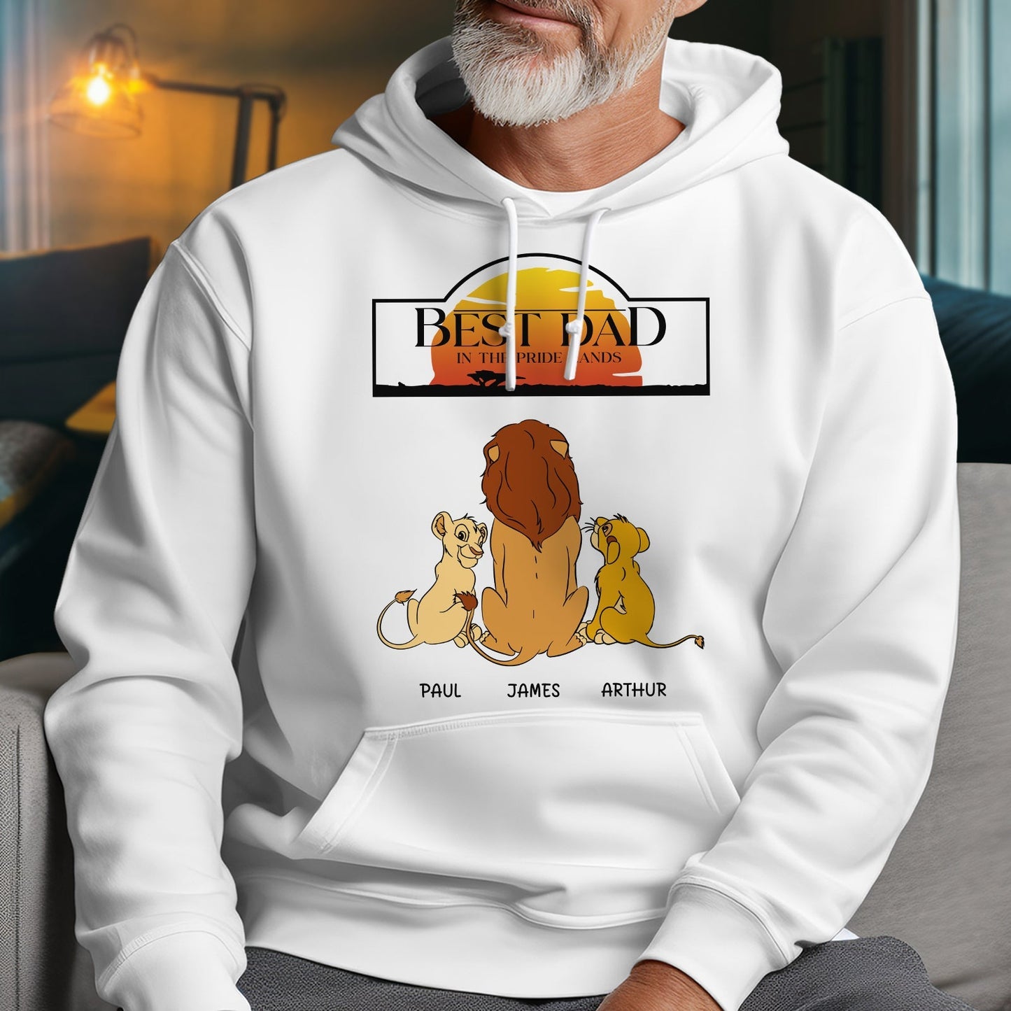 White hoodie with Best Dad in the Pride Lands gift design featuring a lion family and personalized names