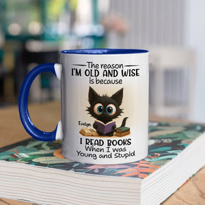 funny personalized accent mug for bookworms featuring a cute black kitten reading a book on white mug with blue handle