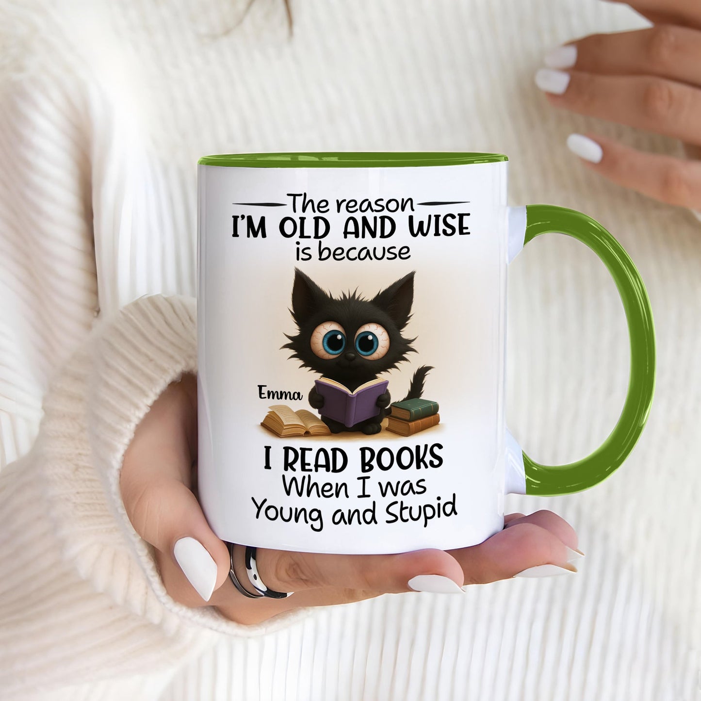 White mug with green handle and wide eyed cat reading books name Emma funny personalized accent mug for bookworms