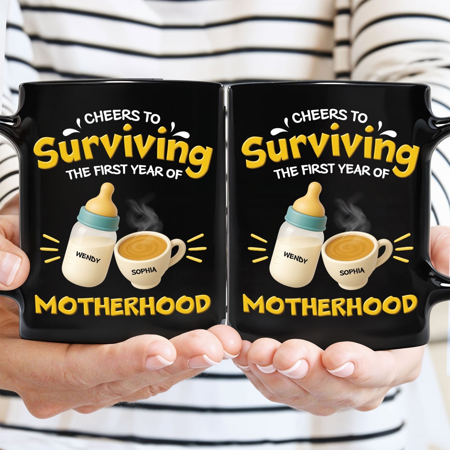 Hands holding pair of black 365Gifty personalized first year of parenthood mug with bottle and coffee design and names