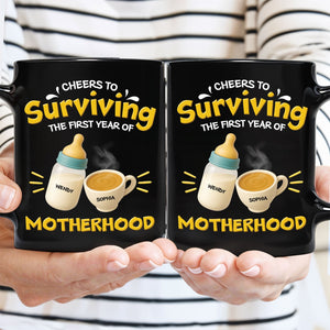 Hands holding pair of black 365Gifty personalized first year of parenthood mug with bottle and coffee design and names
