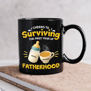 Black ceramic personalized first year of parenthood mug with Cheers to Surviving Fatherhood and bottle and cup with names
