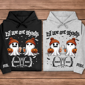 Black and gray hoodies personalized Halloween couple shirt featuring two cute ghosts in orange beanies holding pumpkins and drinks