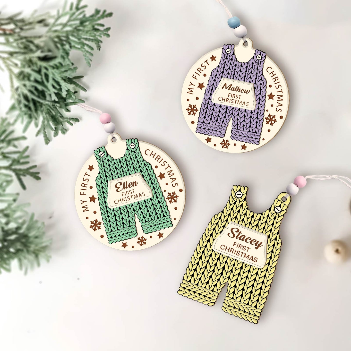 Custom 2-layered Christmas ornament for baby featuring knitted overalls design with personalized names and first Christmas text