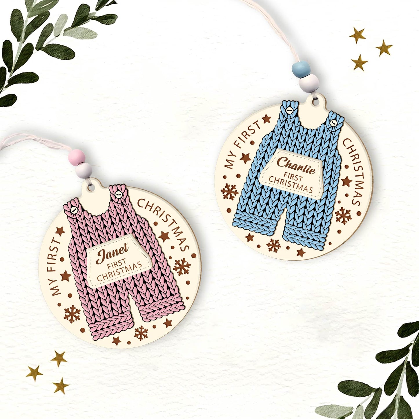 Custom 2-layered Christmas ornament for baby featuring knitted pink and blue rompers with first Christmas names