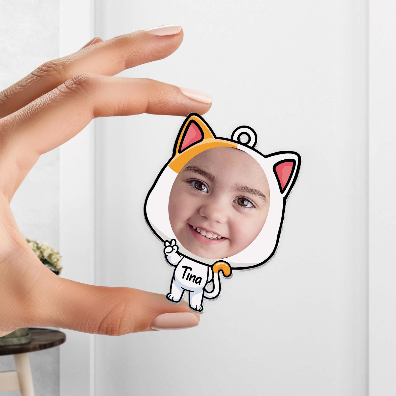 Custom acrylic photo keychain shaped like a cat with a child's photo inside