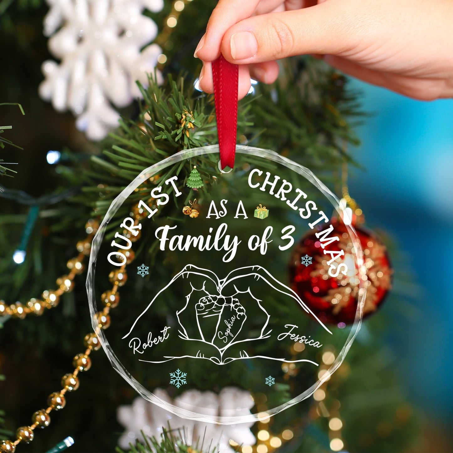 365Gifty custom family Christmas glass ornament with personalized names and red ribbon hanging on tree