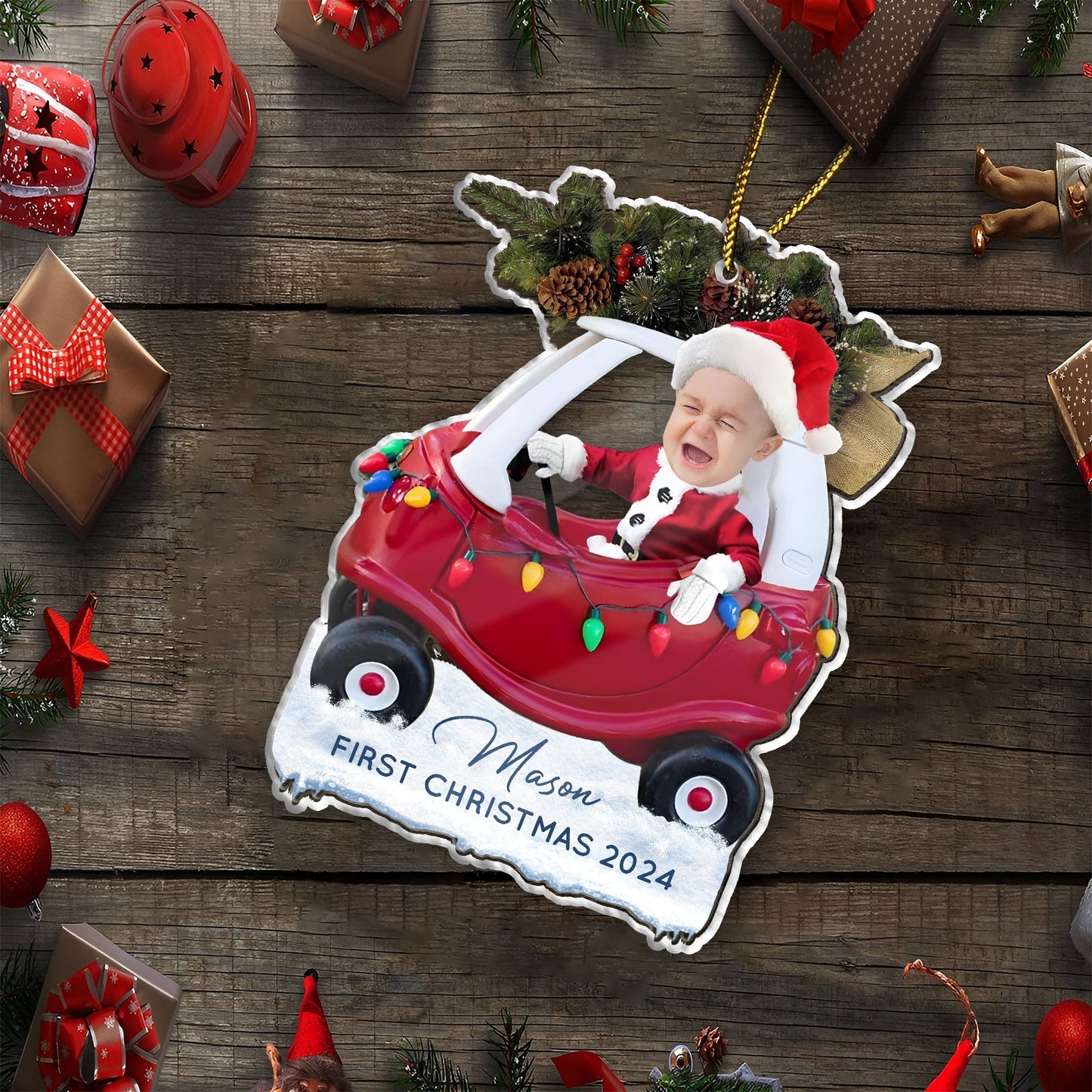 Custom first Christmas acrylic ornament featuring a baby in a red car with holiday lights and Santa hat
