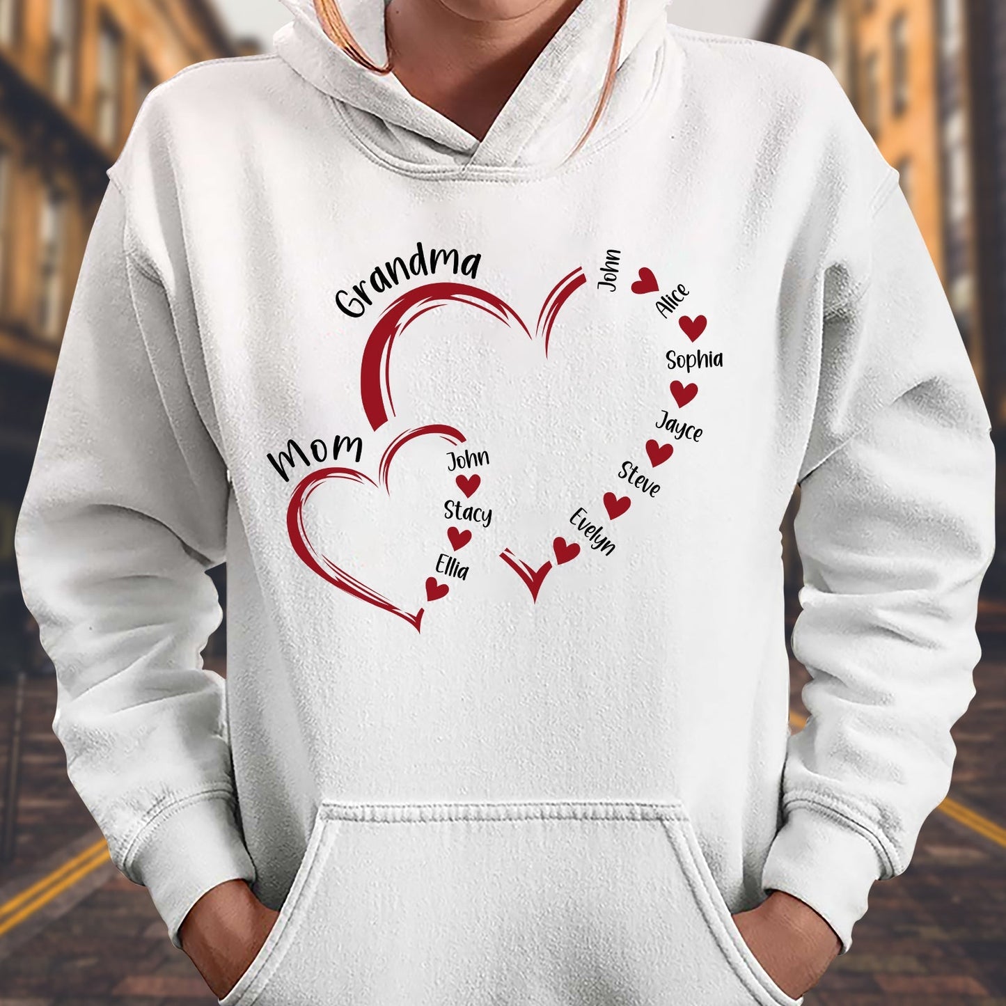 White hoodie featuring a custom light of my life shirt design with red hearts and family names printed