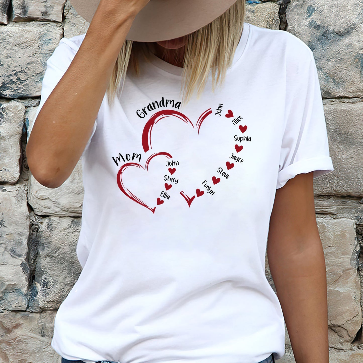 Woman wearing a white custom light of my life shirt with red heart designs and personalized family names