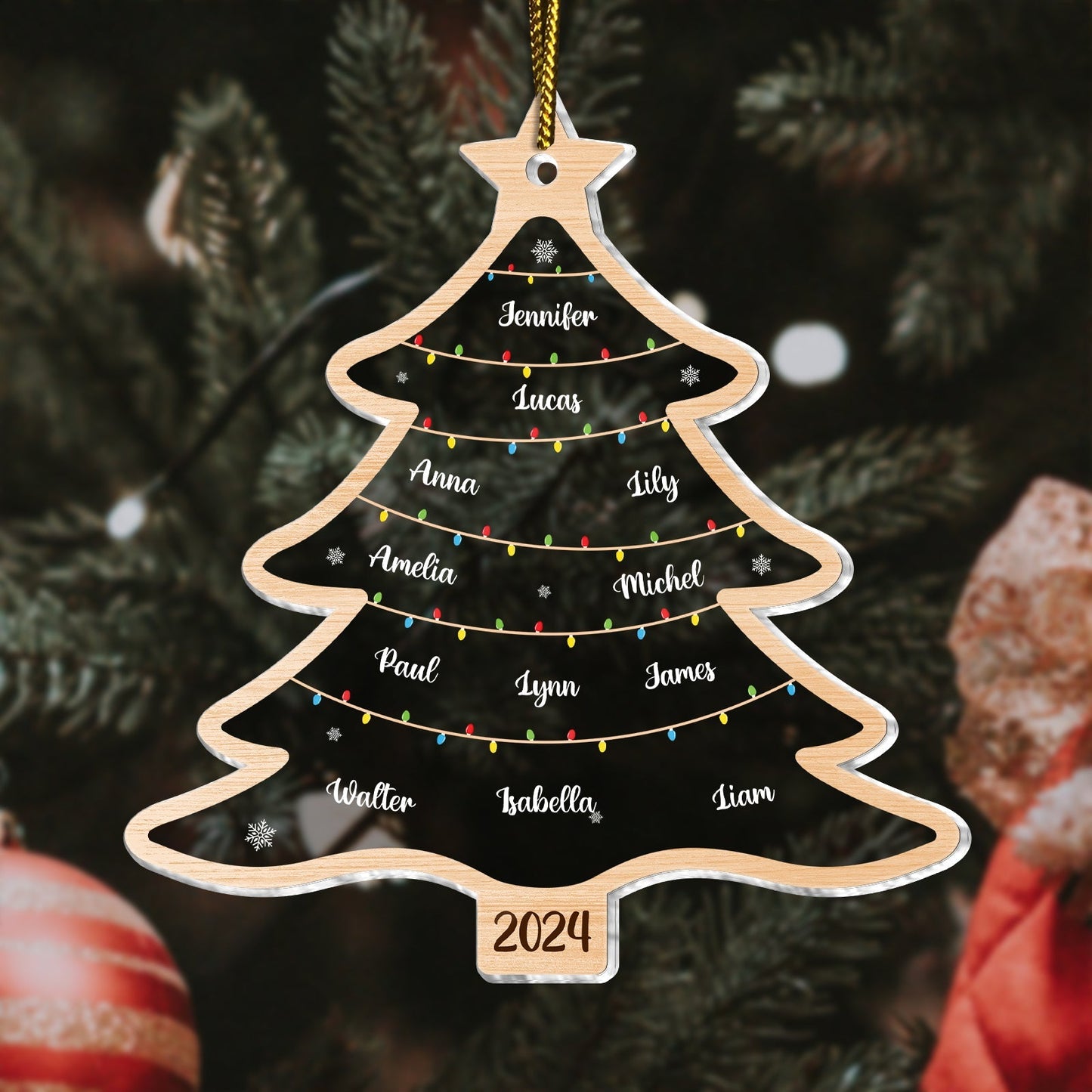 Personalized Christmas tree ornament in wood shape with family names and 2024 date hanging on tree