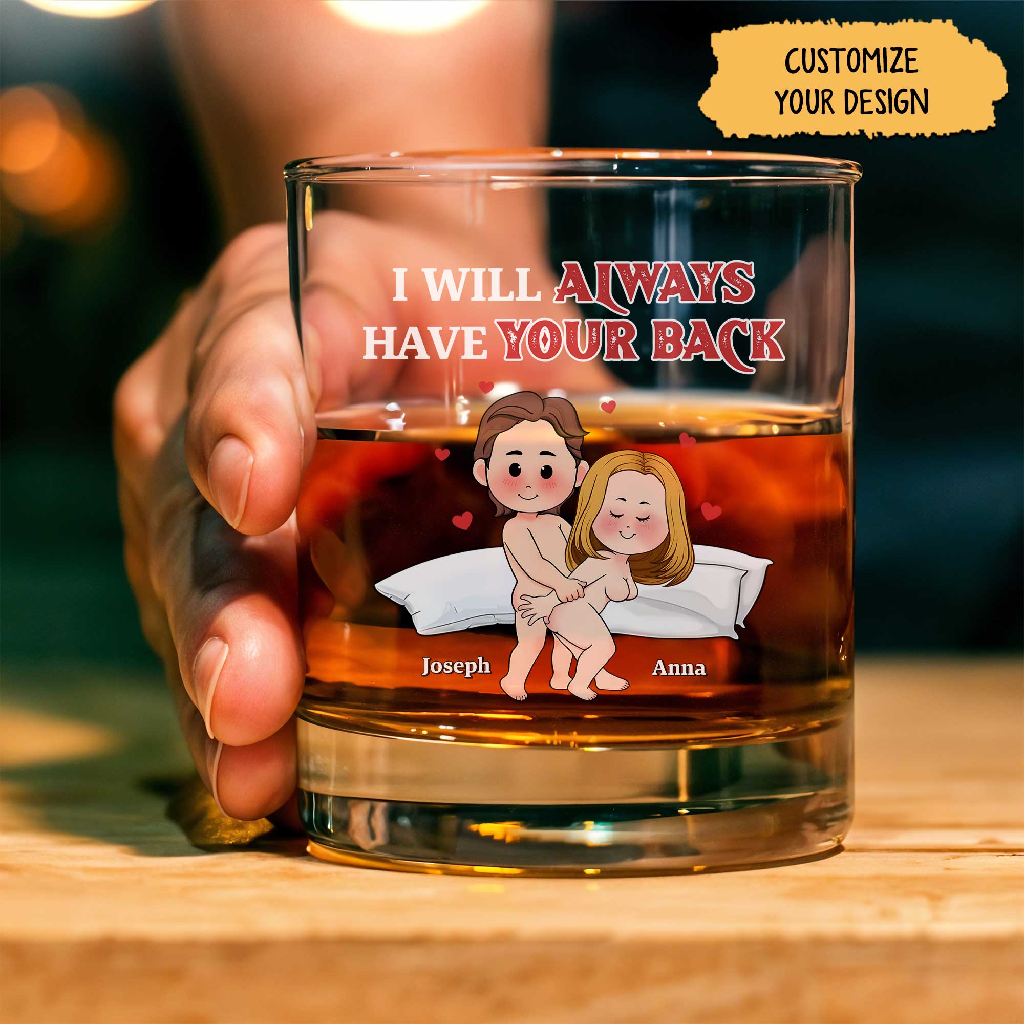 Handheld personalized couple whiskey glass featuring cartoon couple on pillow I will always have your back text with custom names