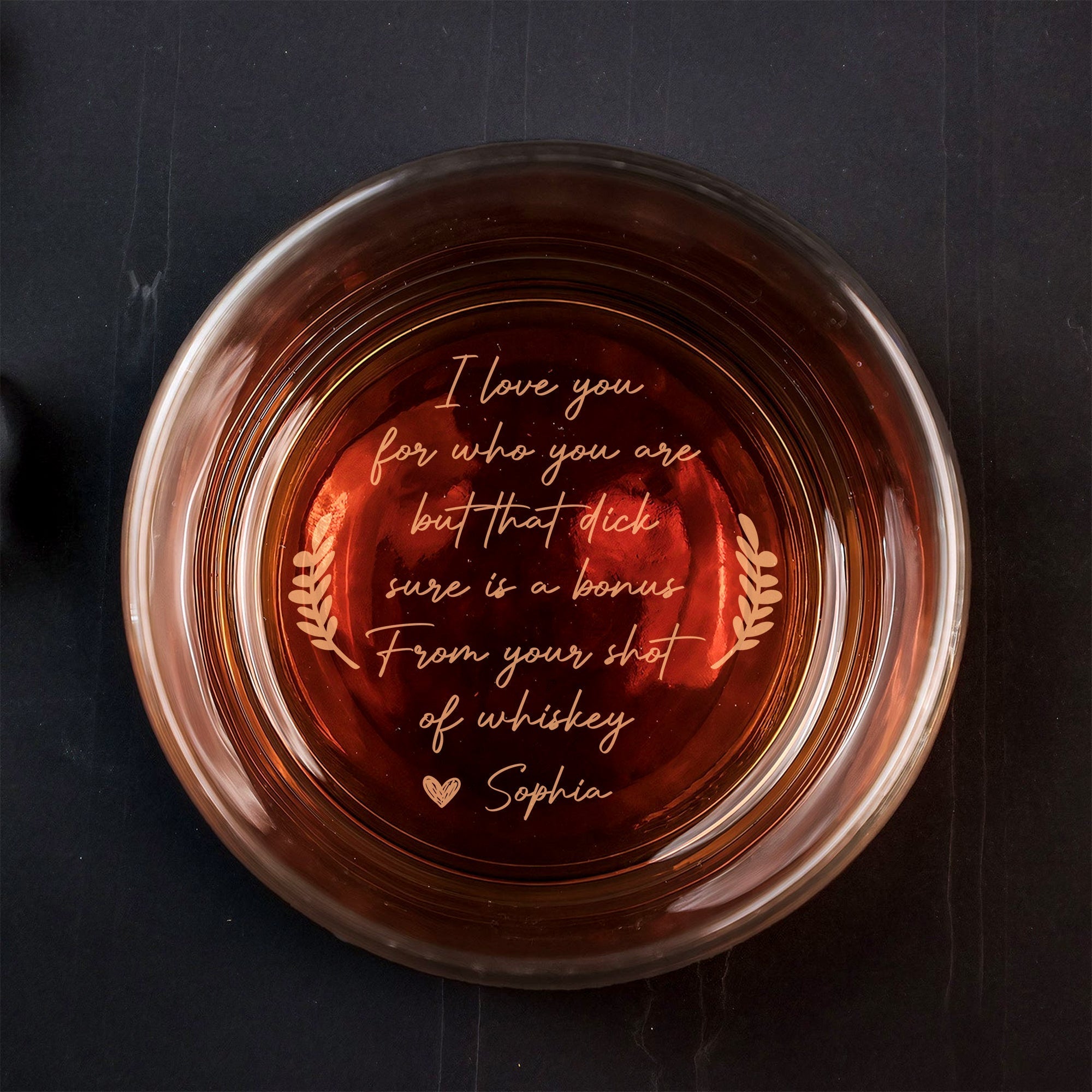 Top view of 365Gifty Personalized Whiskey Glass with amber whiskey and engraved romantic message at base