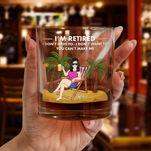 Personalized Whiskey Glass held in hand showing retired woman lounging on beach chair with palm trees and name Sophia