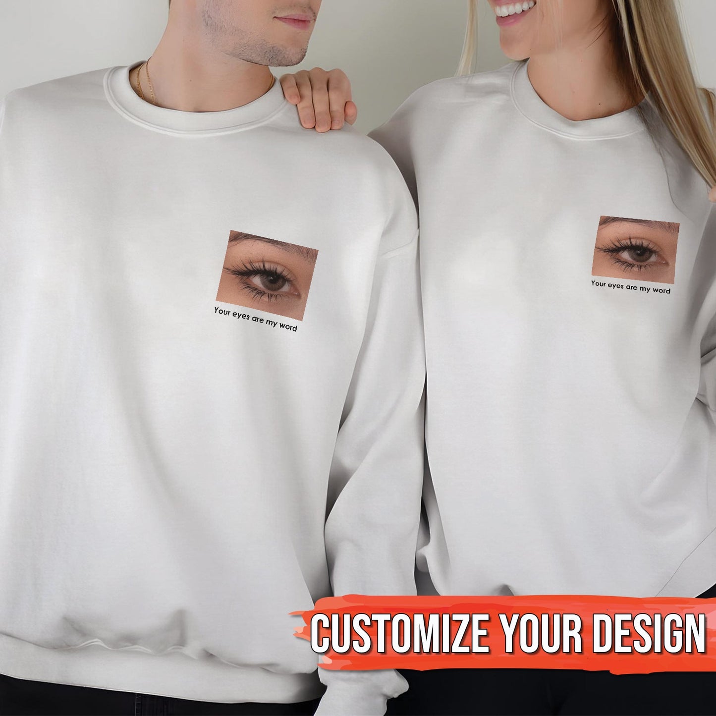 Couple wearing matching white sweatshirts with eye design and text perfect for customized gifts for loved ones