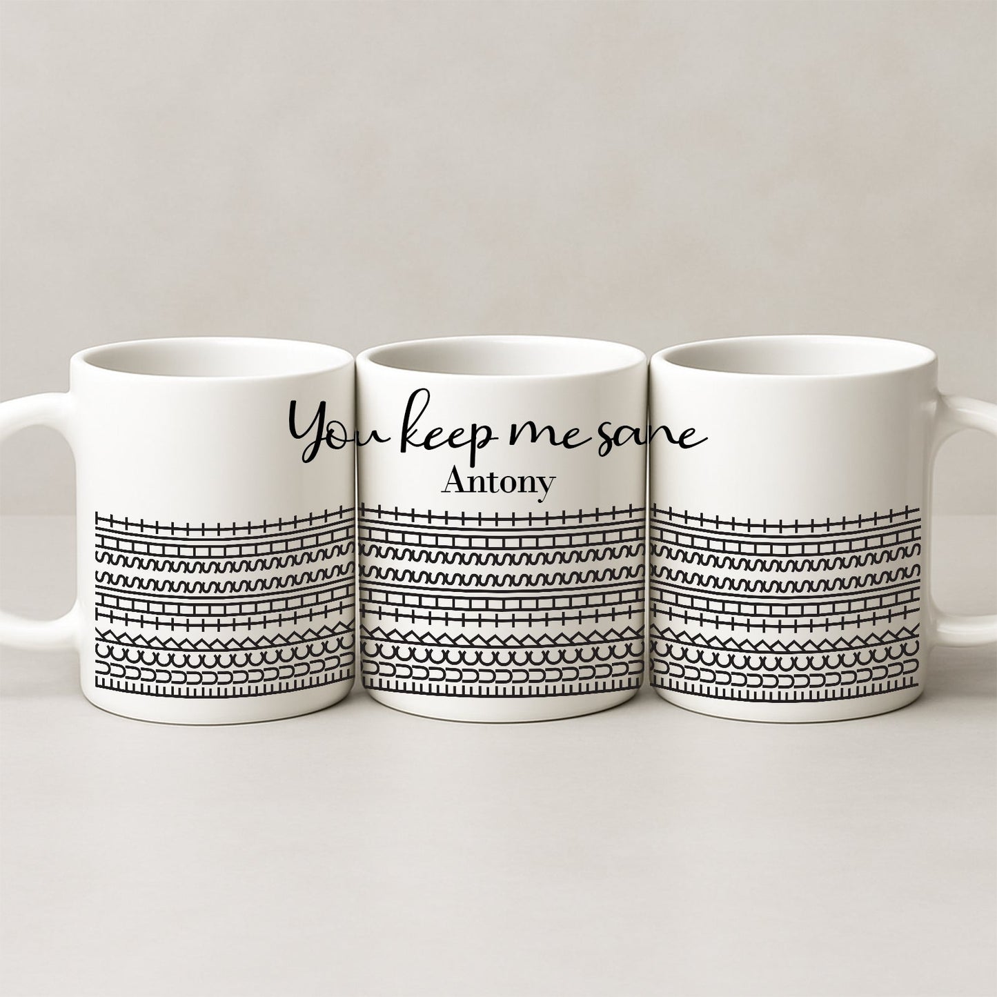 Three white ceramic personalized 'You Keep Me Sane' mug set with black geometric pattern and name Antony