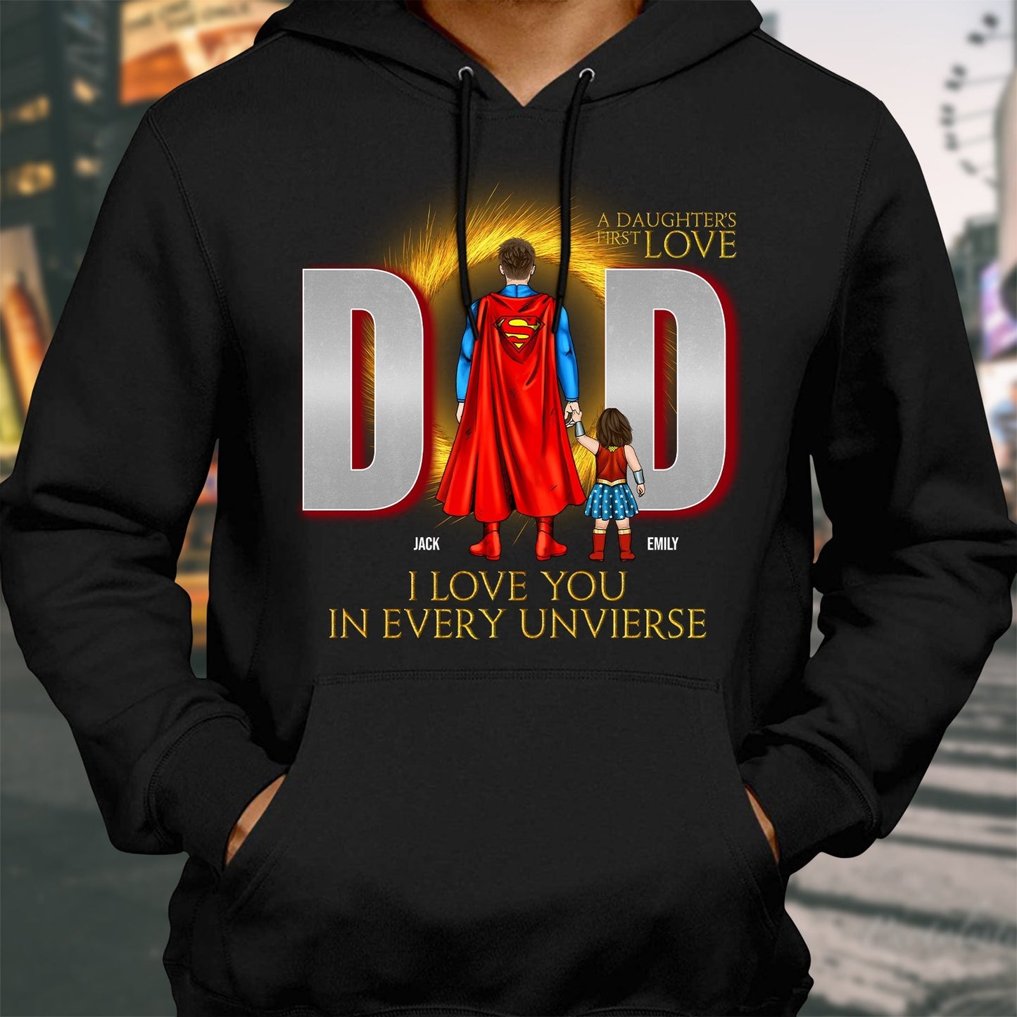 Black hoodie featuring a dad and daughter with superhero cape and I love you in every universe shirt text