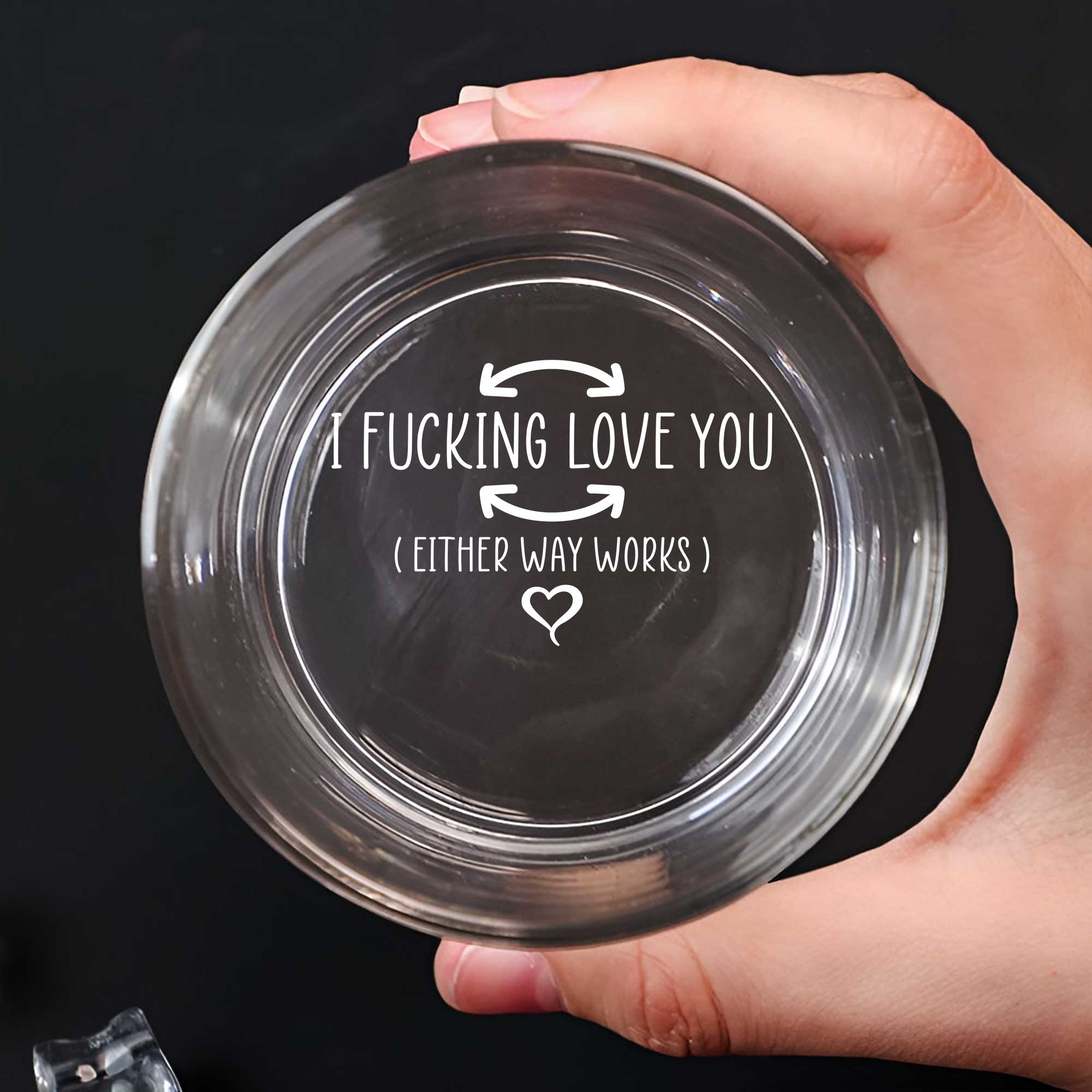 Personalized Whiskey Glass showing engraved message I FUCKING LOVE YOU with arrows and heart held in hand
