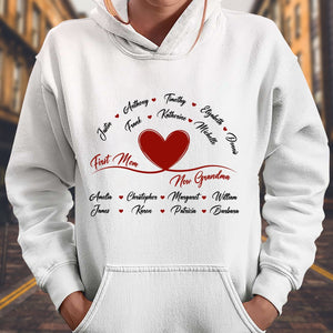 White hoodie with a red heart and personalized names design featuring first mom now grandma gift message