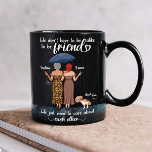 365Gifty black ceramic mug with two friends under an umbrella a dog and the quote we just need to care about each other mug