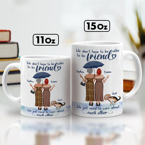 365Gifty we just need to care about each other mug showing two friends under umbrella with dog in 11oz and 15oz