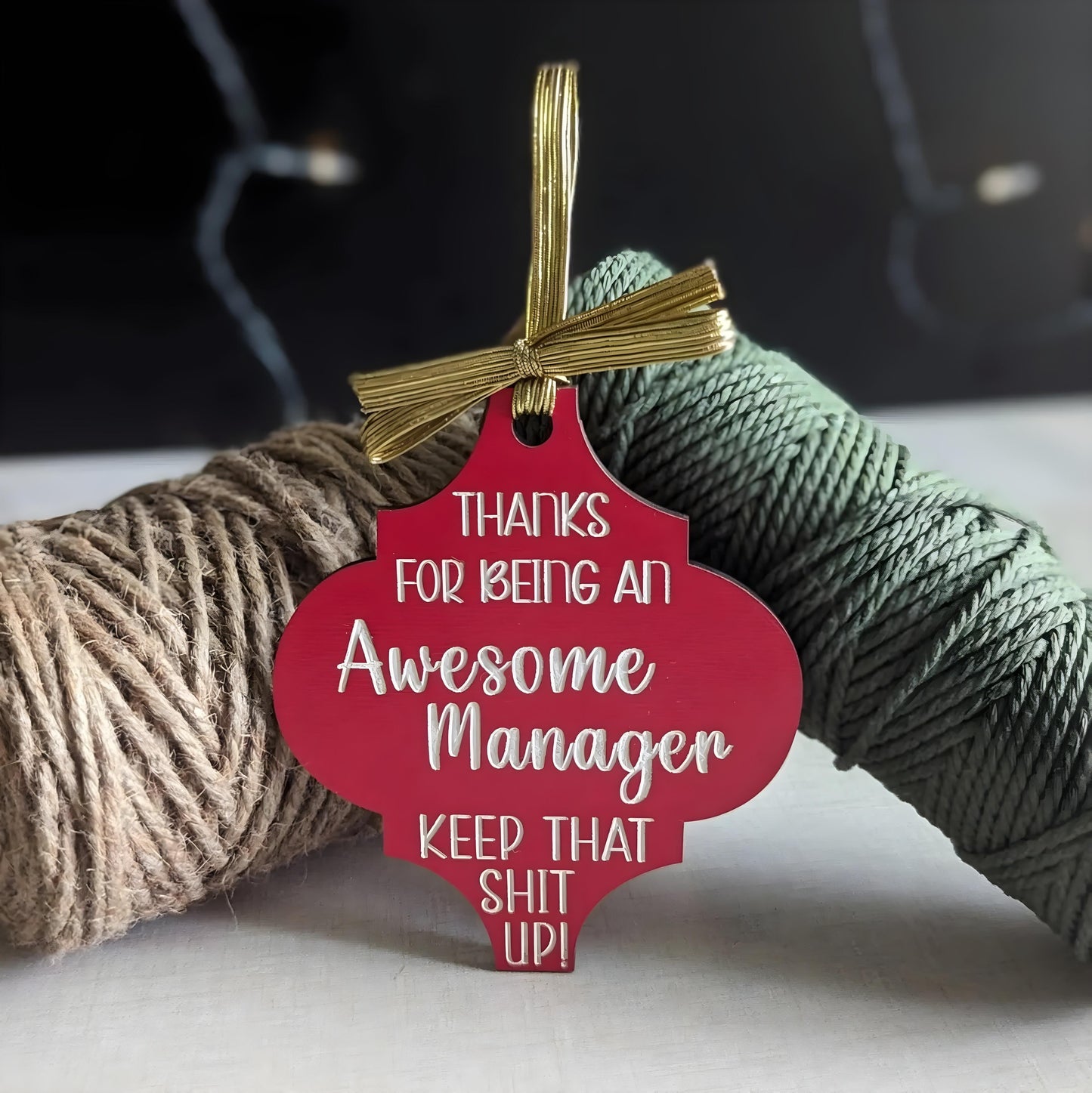 Funny Christmas wooden ornament with red design and message for an awesome manager hanging with decorative twine