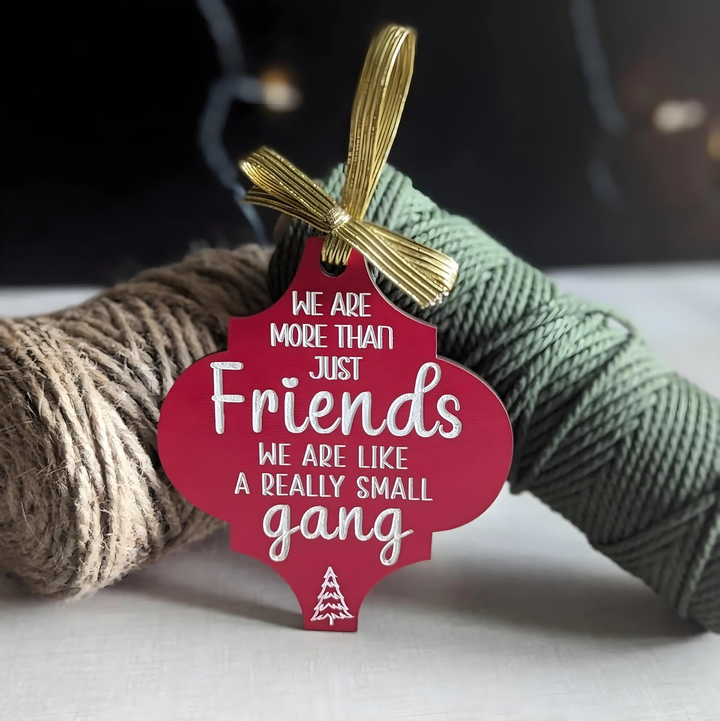 365Gifty funny Christmas wooden ornament in red with white text and gold ribbon saying we are more than just friends