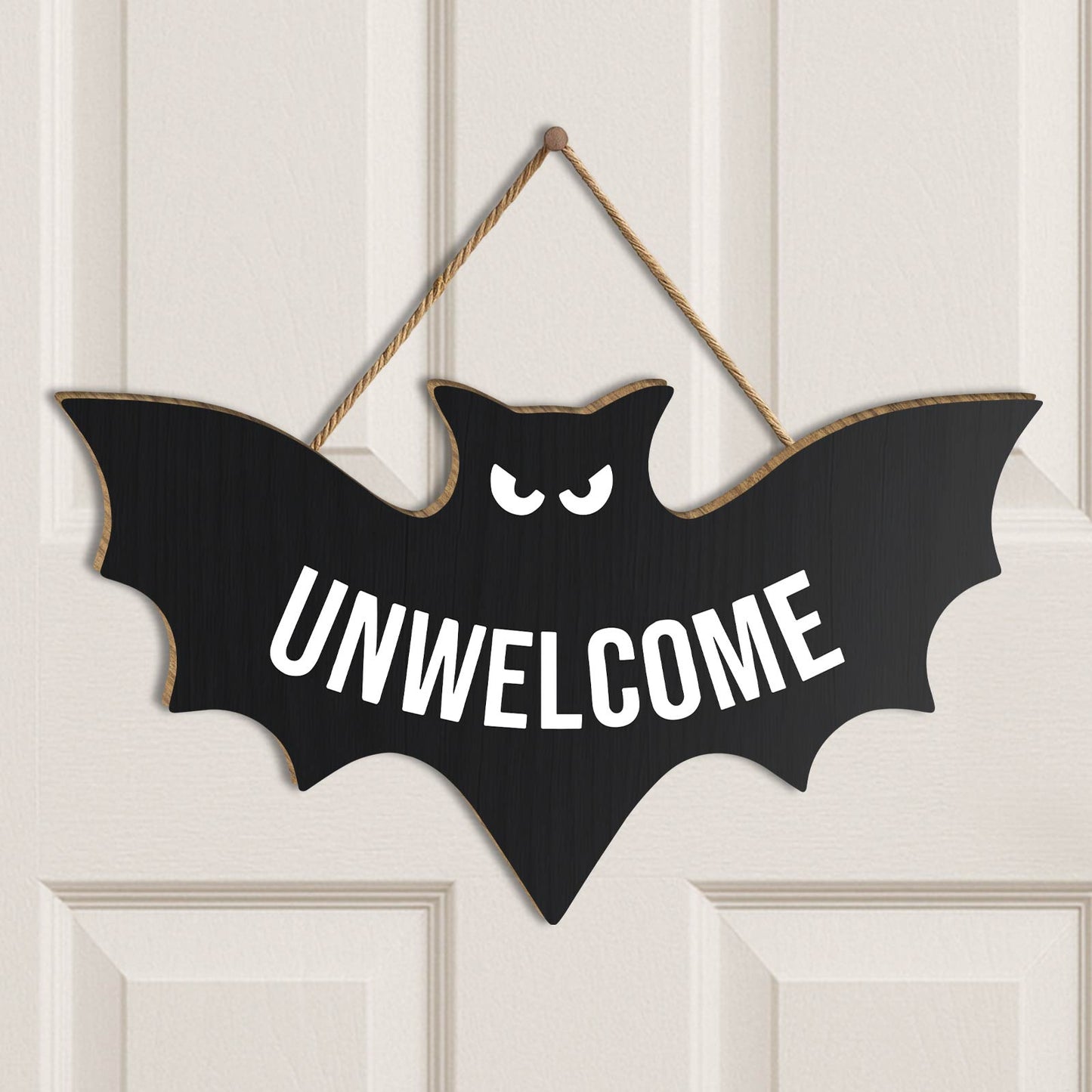 Funny Halloween door sign shaped like a bat with the word UNWELCOME in bold white letters