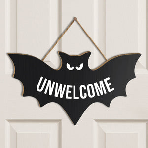 Funny Halloween door sign shaped like a bat with the word UNWELCOME in bold white letters
