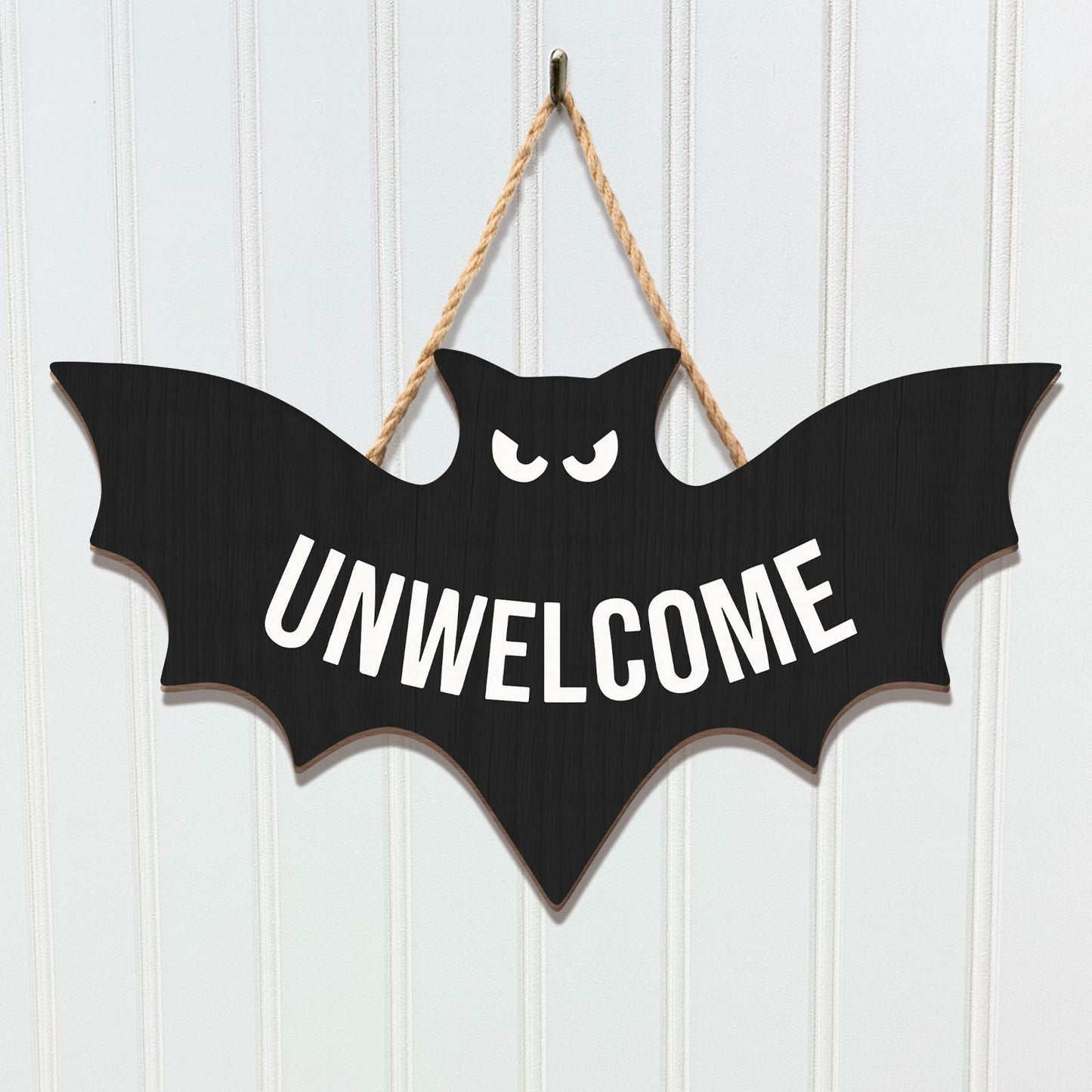 Funny Halloween door sign in the shape of a bat with the word UNWELCOME in bold letters