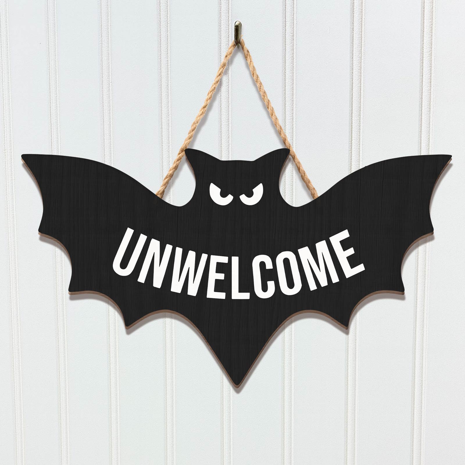 Funny Halloween door sign in the shape of a bat with the word UNWELCOME in bold letters