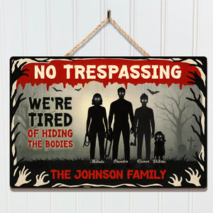 Halloween Wooden Door Sign featuring a spooky design with a family silhouette and a playful message