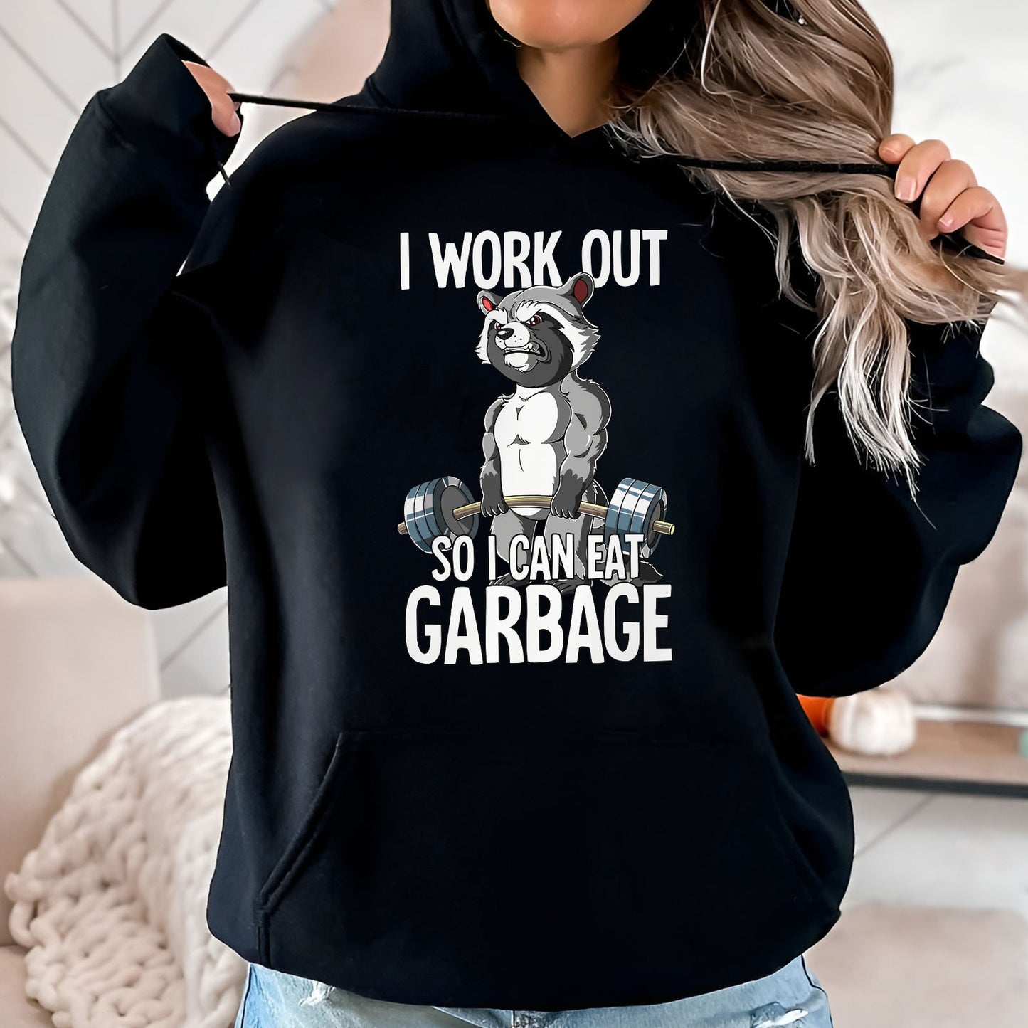 Black hoodie with humorous workout apparel featuring muscular raccoon lifting weights and funny text