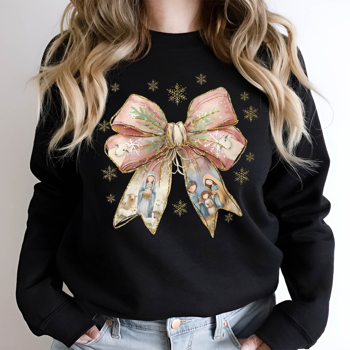 Black sweatshirt featuring a large Jesus Christmas bow shirt design with nativity scenes and gold snowflakes