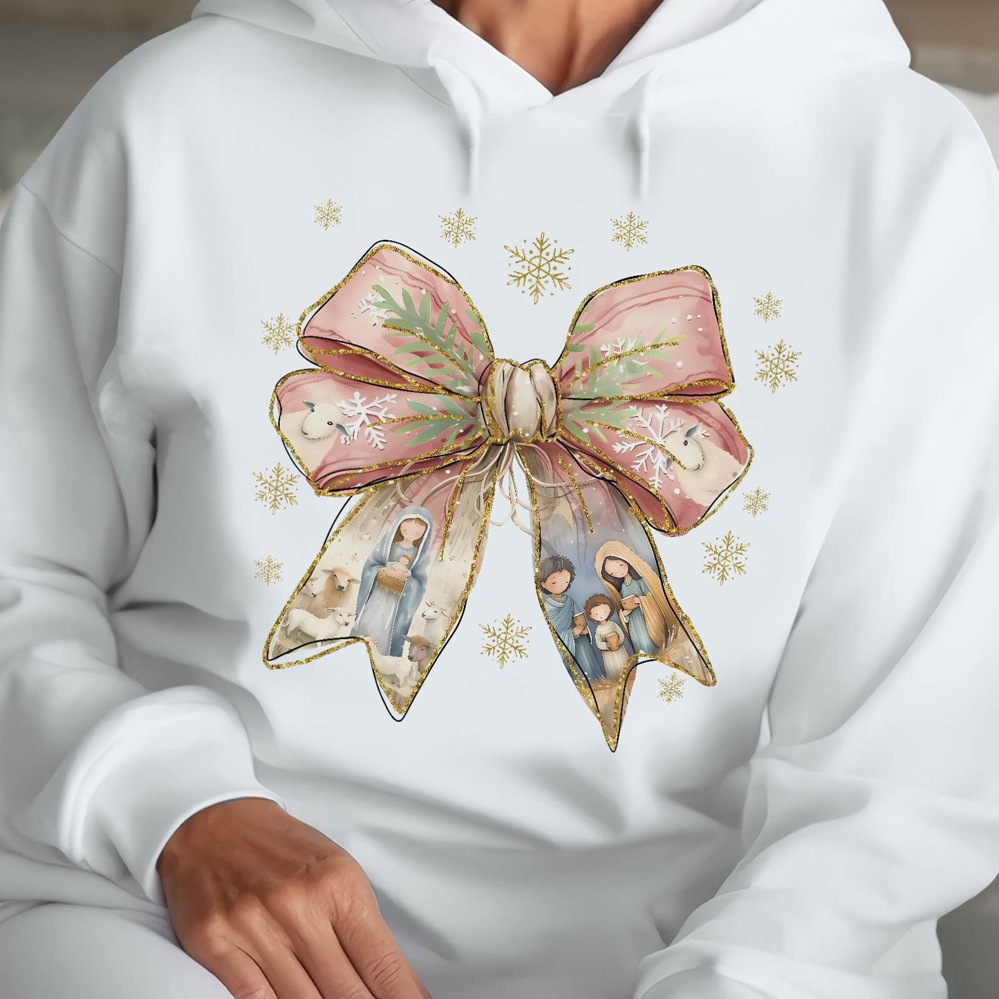 White hoodie with a Jesus Christmas bow shirt design featuring a pink bow and nativity scene details