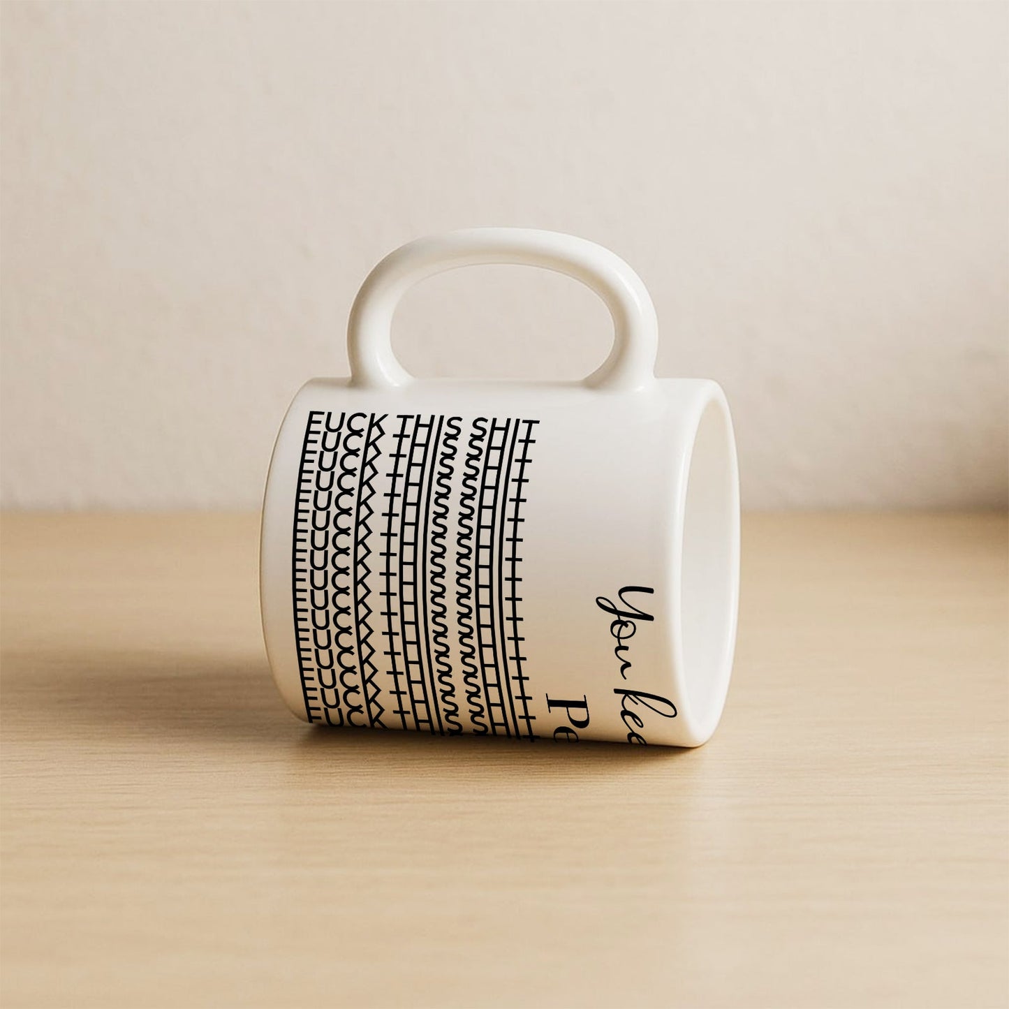 White ceramic personalized 'You Keep Me Sane' mug with black pattern and rounded handle on wooden surface