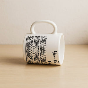 White ceramic personalized 'You Keep Me Sane' mug with black pattern and rounded handle on wooden surface