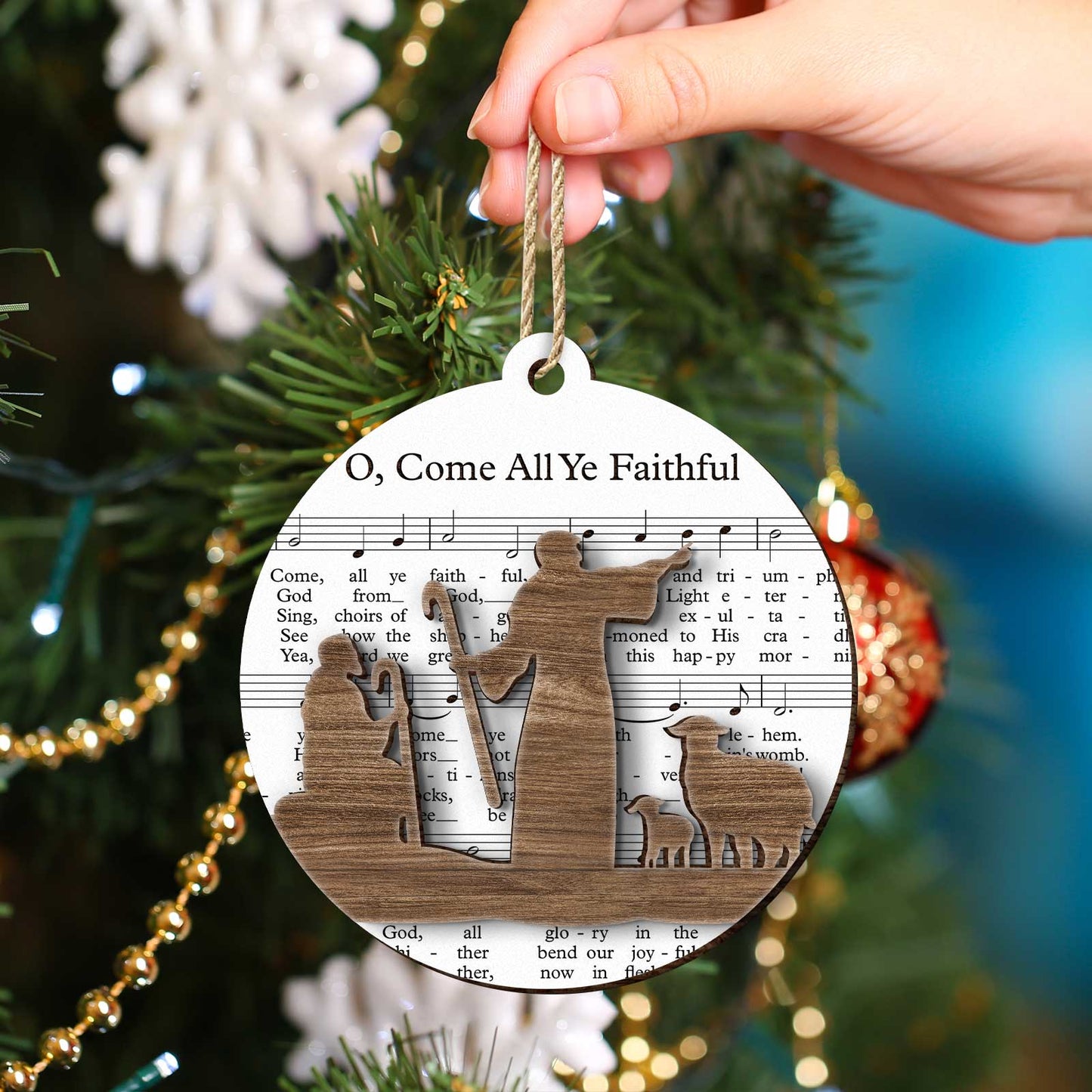 365Gifty music sheet nativity ornament with wooden holy family silhouette hanging on Christmas tree