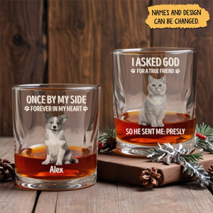 Two personalized pet memorial whiskey glass set featuring dog and cat portraits memorial text and custom names on wooden table
