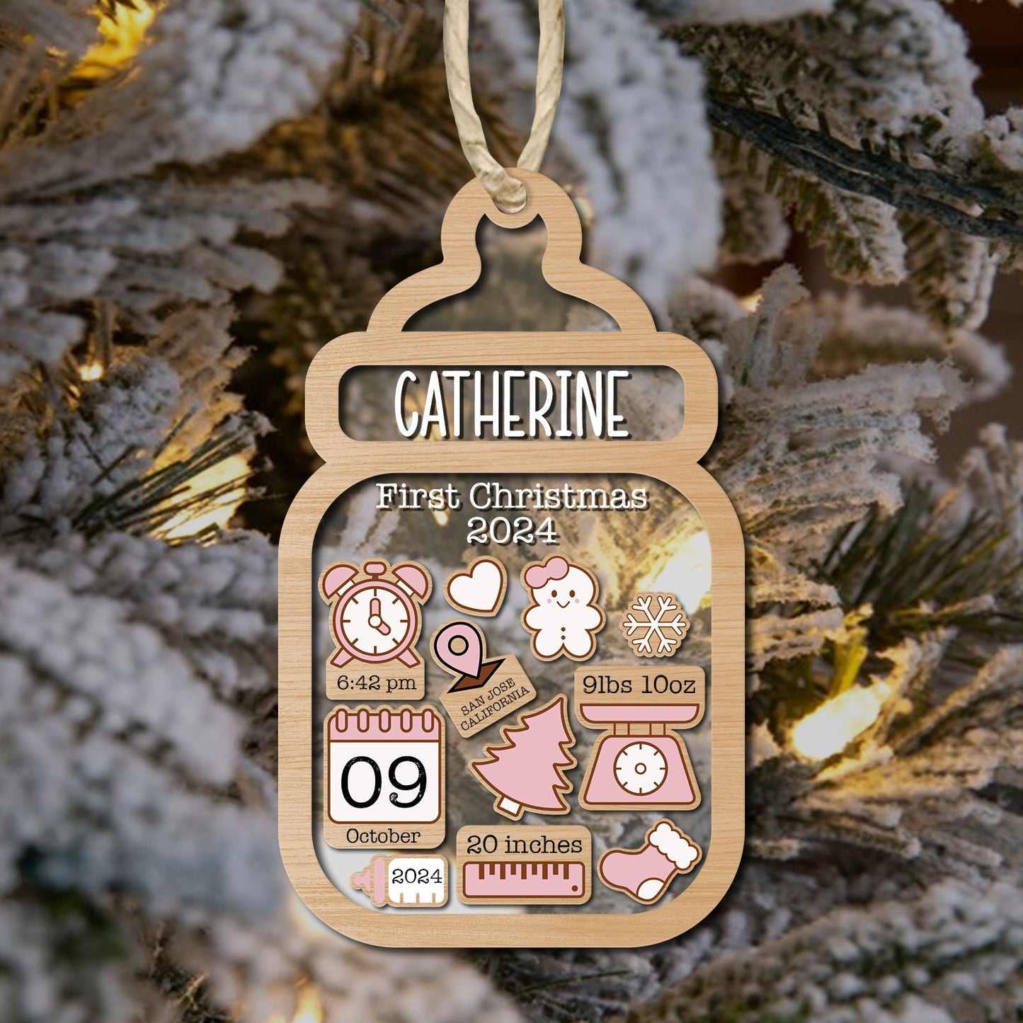 Personalized baby first Christmas ornament shaped like a baby bottle with name Catherine and birth details
