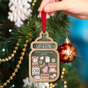 Personalized baby first Christmas ornament with name Catherine and birth details hanging on tree