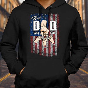 Black hoodie featuring a personalized best dad ever shirt design with fists bumping over an American flag background
