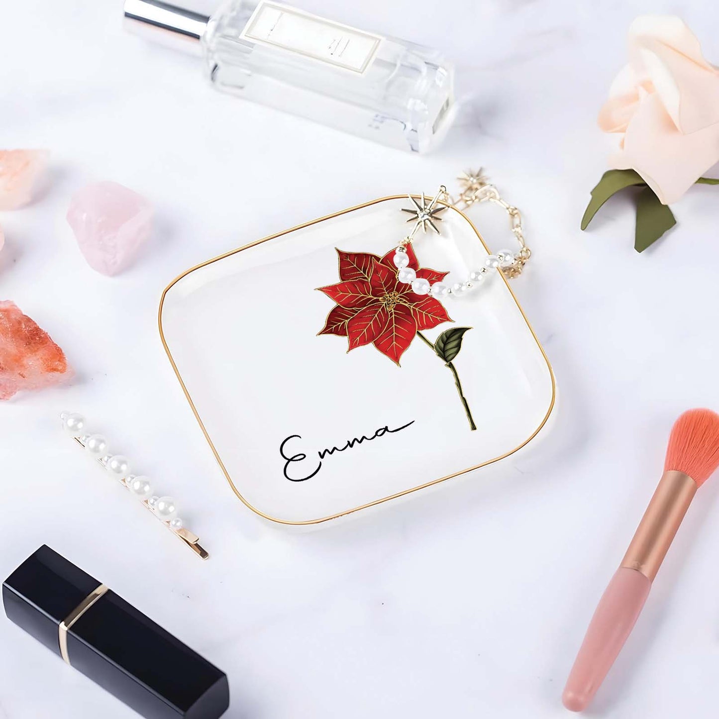 Personalized birth month flower jewelry dish featuring a red flower and the name Emma