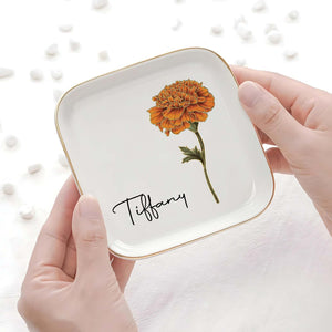 Personalized birth month flower jewelry dish featuring a marigold and the name Tiffany